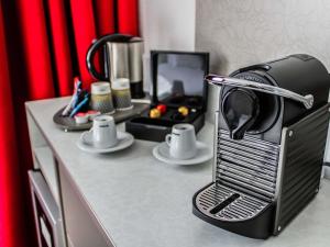 a toaster oven sitting on top of a counter at Mercure Tours Nord in Tours +148 photos