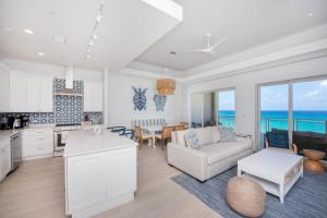 a kitchen and living room with a view of the ocean at Beachcomber 39 in George Town +13 photos