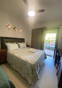 a bedroom with a bed and a window at Pousada Chantilly in São Miguel do Gostoso +46 photos