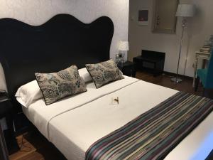 Postel nebo postele na pokoji v ubytování Hotel Calzada