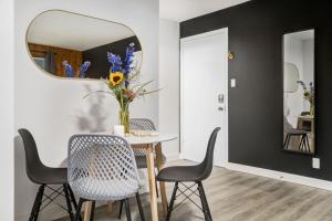a dining room with a table with chairs and a mirror at Gateway Suites Near Canmore and Banff in Canmore