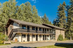 a large building with a porch and balcony at Gateway Suites Near Canmore and Banff in Canmore