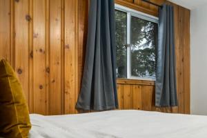 a bedroom with a bed and a window at Gateway Suites Near Canmore and Banff in Canmore +9 photos