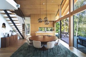 a kitchen and dining room with a wooden table and chairs at Stay North - Adevilla in Mussalo