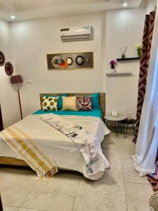 a bedroom with a bed in a room at LUXES Studio in Dakar