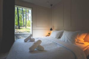 a bedroom with a bed with two stuffed animals on it at Stay North - Adevilla in Mussalo +31 photos