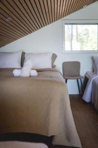a bedroom with a large bed and a window at Stay North - Adevilla in Mussalo