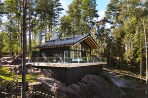 a house in the middle of a forest at Stay North - Adevilla in Mussalo