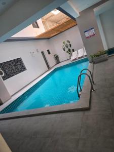 a large swimming pool in a building with a swimming pool at LUXES Studio in Dakar