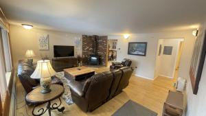 a living room with leather furniture and a table at Frontier Lux 2 Bedroom in Hamilton Acres