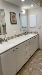 a bathroom with two sinks and a large mirror at Frontier Lux 2 Bedroom in Hamilton Acres