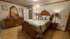 a bedroom with a bed and a dresser and a mirror at Frontier Lux 2 Bedroom in Hamilton Acres