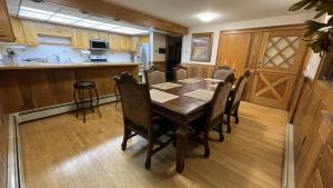 a dining room with a table and chairs in a kitchen at Frontier Lux 2 Bedroom in Hamilton Acres +11 photos