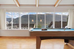 a pool table in a room with a large window at Roestbakken Horizon in Guleng