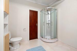 a bathroom with a glass shower and a toilet at Roestbakken Horizon in Guleng +14 photos