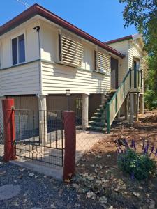 a house with a fence in front of it at Trinity House in Wondai