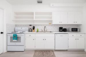 a white kitchen with white cabinets and a sink at The Residences at Lake Ridge Apt 1 in Fort Lauderdale