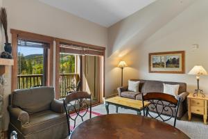 a living room with a couch and a table at Red Hawk Lodge 2312 by Summit County Mountain Retreats in Snake River Health Services Incorporated Heliport