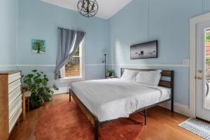 a bedroom with a bed and a tv on the wall at Sea View, Sauna, Hot Tub, Beach Bikes, Stream in Ventura