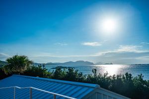 a view of a body of water with the sun at 糸島絶景スイートヴィラ #愛犬と泊まれる宿 #プライベートサウナ付き in Itoshima