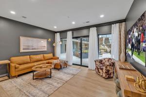 a living room with a couch and a table at Hyve - Southern Comfort - Walk to Broadway in Nashville