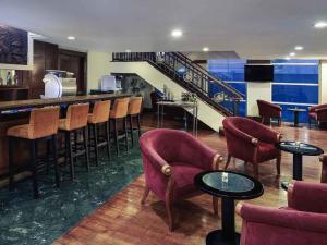 a bar with chairs and tables in a room at Mercure Jakarta Kota in Jakarta +44 photos