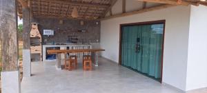 a kitchen with a counter and a table and chairs at Vila Arcanjo in Santana do Riacho