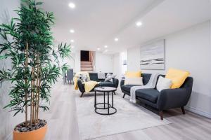 ein Wohnzimmer mit zwei Sofas und einem Tisch in der Unterkunft Bright & Cozy Home in the GTA (Basement Apartment) in Whitby