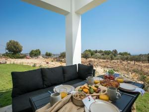 a table with food on top of a couch at Secluded Villa with Panoramic Sea View in Rhodes Town
