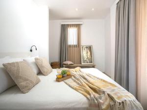a bedroom with a white bed with a tray on it at Secluded Villa with Panoramic Sea View in Rhodes Town