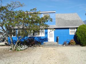 a blue house with a tree in front of it at Rasmusson 17121 in Waretown