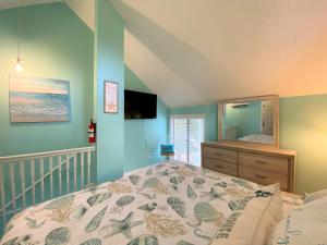 a bedroom with a bed and a dresser and a mirror at 423 Sea Cloud in Edisto Island +19 photos