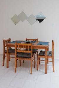 a wooden table with two chairs and a table with a lamp at Iris appartement salé rabat in Sale