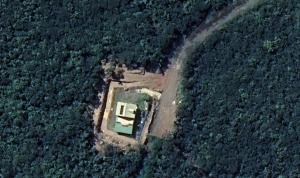 an aerial view of a house in a field at Chambre indépendante calme pour femmes, en forêt, 1km plage in Deshaies