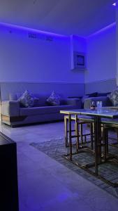 a living room with a couch and a table at شقه بإطلاله للبحر داماك جدة in Jeddah