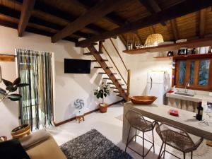 a kitchen with a table and chairs in a room at Casinha Mandala 2 - Taipu de Fora in Taipu