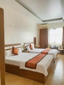 a hotel room with two beds in a room at Cat Ba island Budget Pool Stay in Cat Ba +17 photos