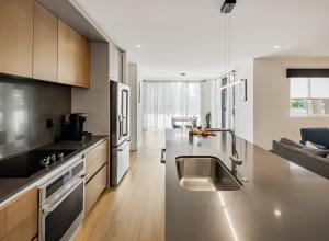 a kitchen with a stainless steel sink and a counter at Coach House - Hot Tub - Heart of Old Town in Scottsdale