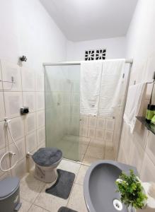 a bathroom with a shower and a toilet and a sink at Casa de Hospedagem Cajueiro in Jijoca de Jericoacoara +40 photos