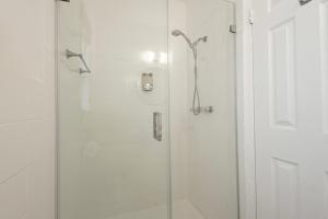 a bathroom with a shower with a glass door at The Oasis in Miami