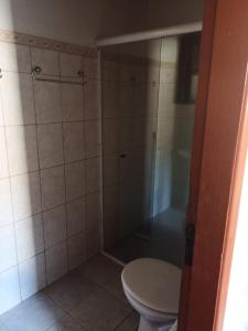 a bathroom with a toilet and a shower at Pousada costa in Paraty +6 photos