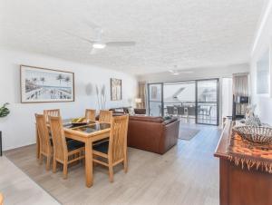 a living room with a table and a couch at Sunrise Cove 25 in Kingscliff