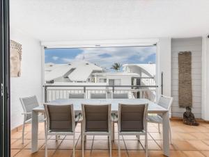 a dining room with a table and chairs on a balcony at Sunrise Cove 25 in Kingscliff