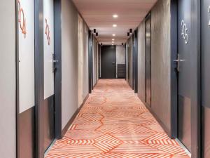 a corridor of elevators in a hotel with a carpet at Mercure Marseille Centre Prado Vélodrome in Marseille