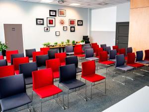 a conference room with red and black chairs at Ibis Poznan Stare Miasto in Poznań