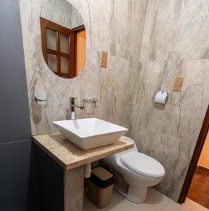 a bathroom with a sink and a toilet and a mirror at Apartamento de 1 habitación en planta baja in Sucre