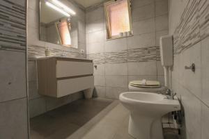 a bathroom with a toilet and a sink and a mirror at BED&FLY NEAR AIRPORT CATANIA FONTANAROSSA BAGNO PRIVATO In CAMERA in Catania +50 photos