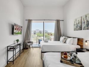 a hotel room with two beds and a balcony at Horizon - 2 Units - Jacuzzi - Private Balconies in Scottsdale +69 photos