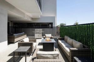 a patio with a couch and tables and a grill at Horizon - 2 Units - Jacuzzi - Private Balconies in Scottsdale