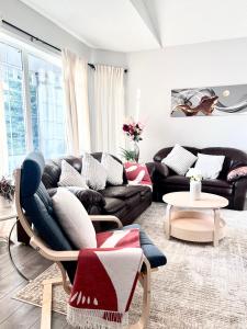 a living room with a couch and a chair at Spacious main floor suite in Detached Bungalow with Parking & Kitchen in Calgary